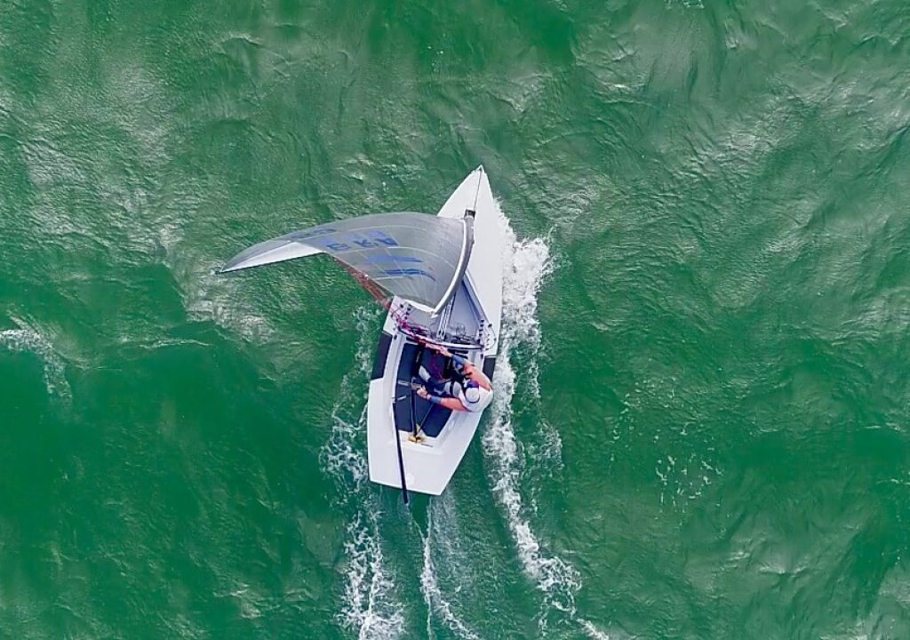 Aerial view of a Finn reaching on green water